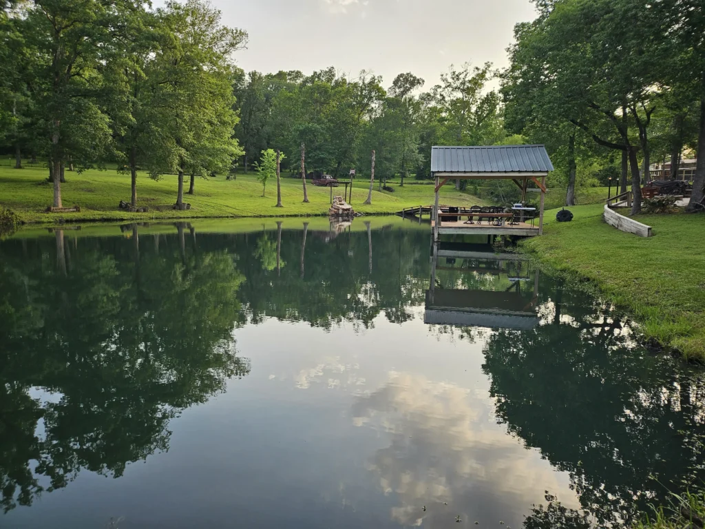 The pond and covered dock at dusk at Inner Peace and Happiness Ranch
