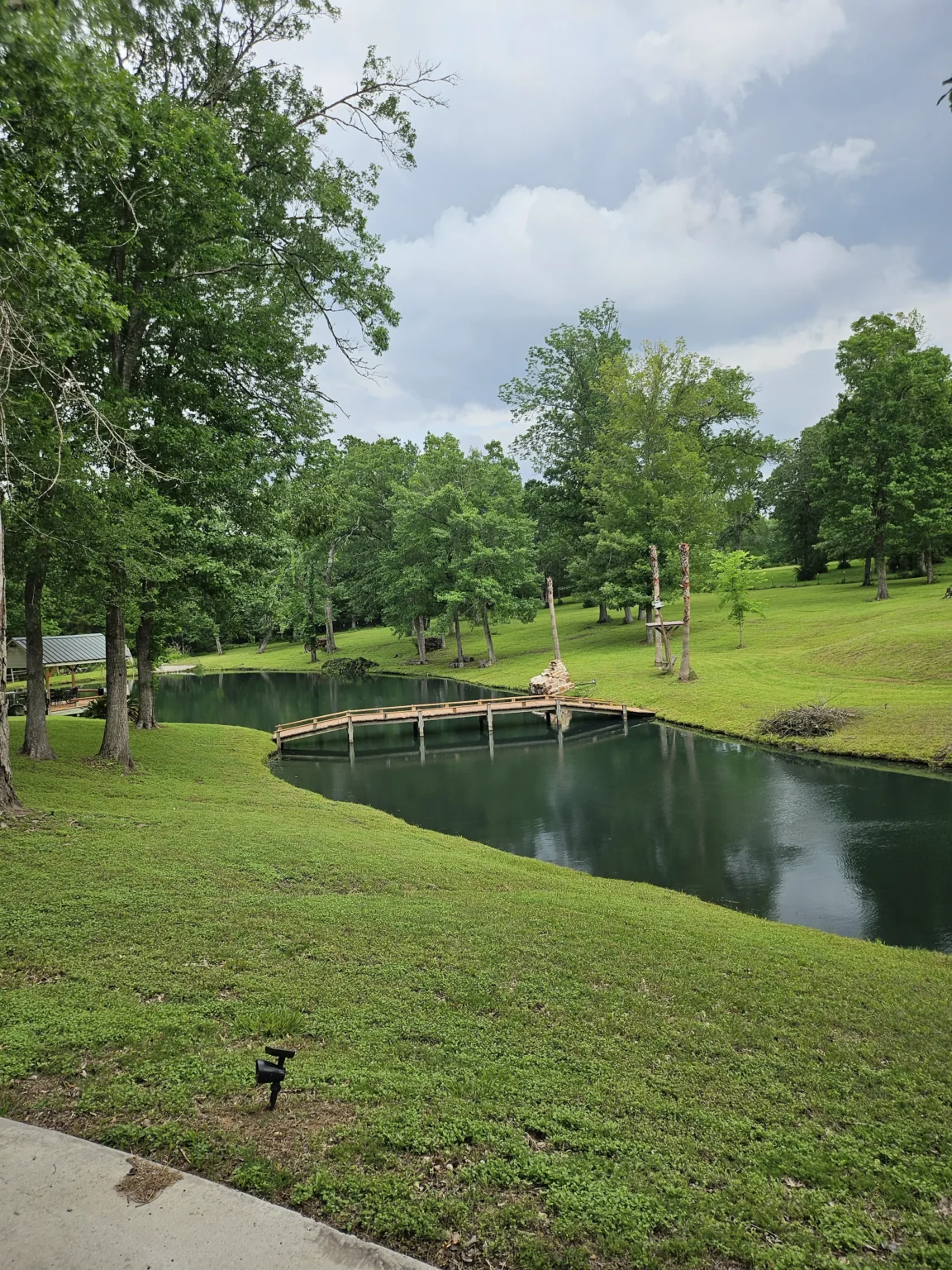 The pond and wooden bridge at Inner Peace and Happiness Ranch