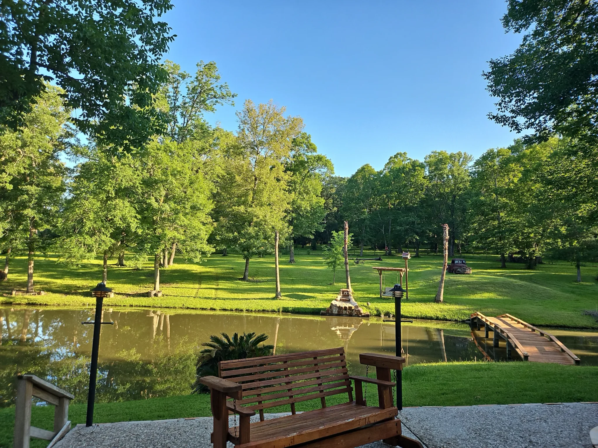 The peaceful pond and green landscape at Inner Peace and Happiness Ranch in Coldspring, Texas