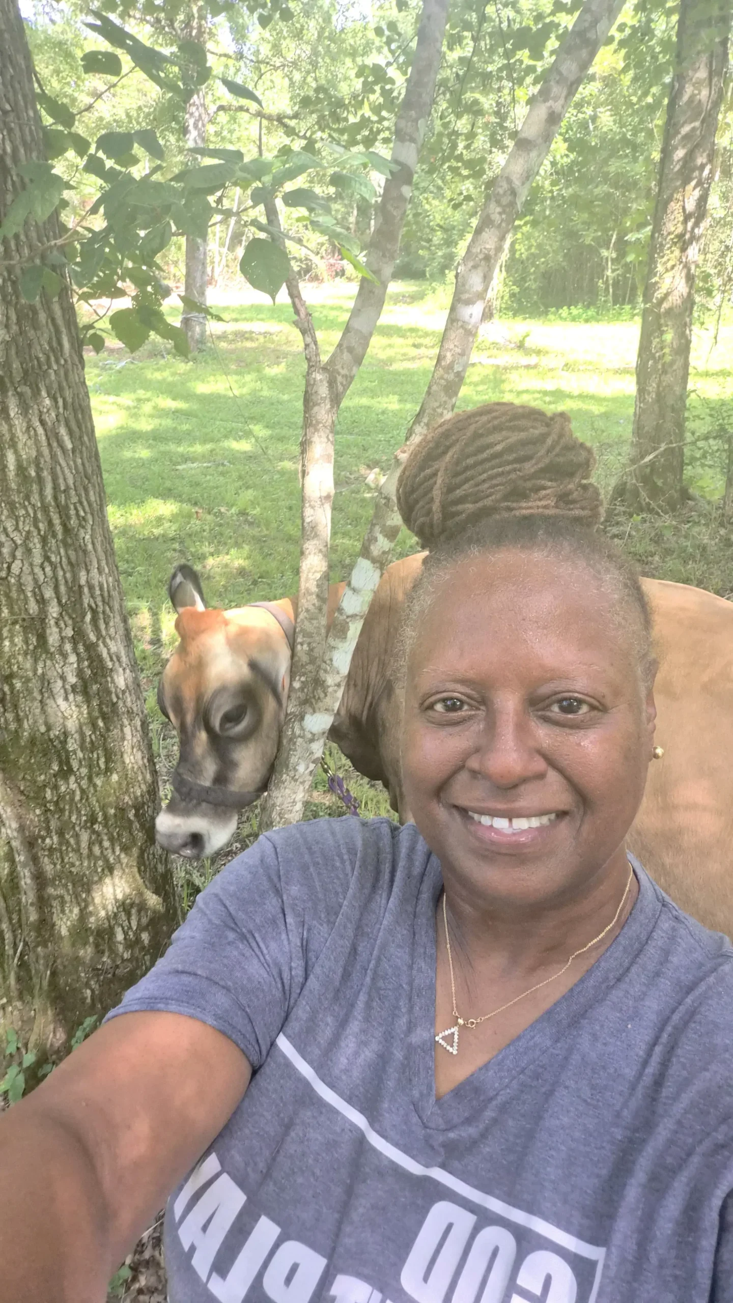 Rosalind Smith owner of Inner Peace and Happiness Ranch smiling with Bella Jersey cow